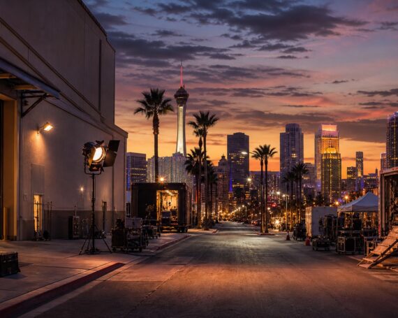Las Vegas entertainment production street with studio lighting and skyline at dusk.